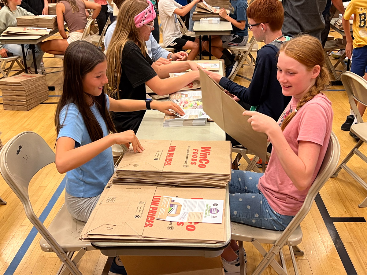 Hundreds prep food drive bags for Community Service Day